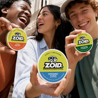 Three smiling people outdoors each hold a round ZOID branded energy pouch tin toward the camera. The center tin is larger and reads Peppermint Plunge, while the side tins read Citrus Slingshot and Wintergreen Wonderland.
